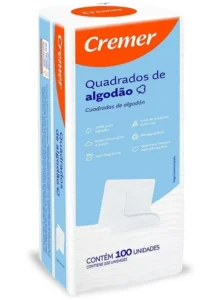 Caixa retangular com o rótulo azul claro, branco e laranja em destaque. Quadrados de algodão da marca Cremer